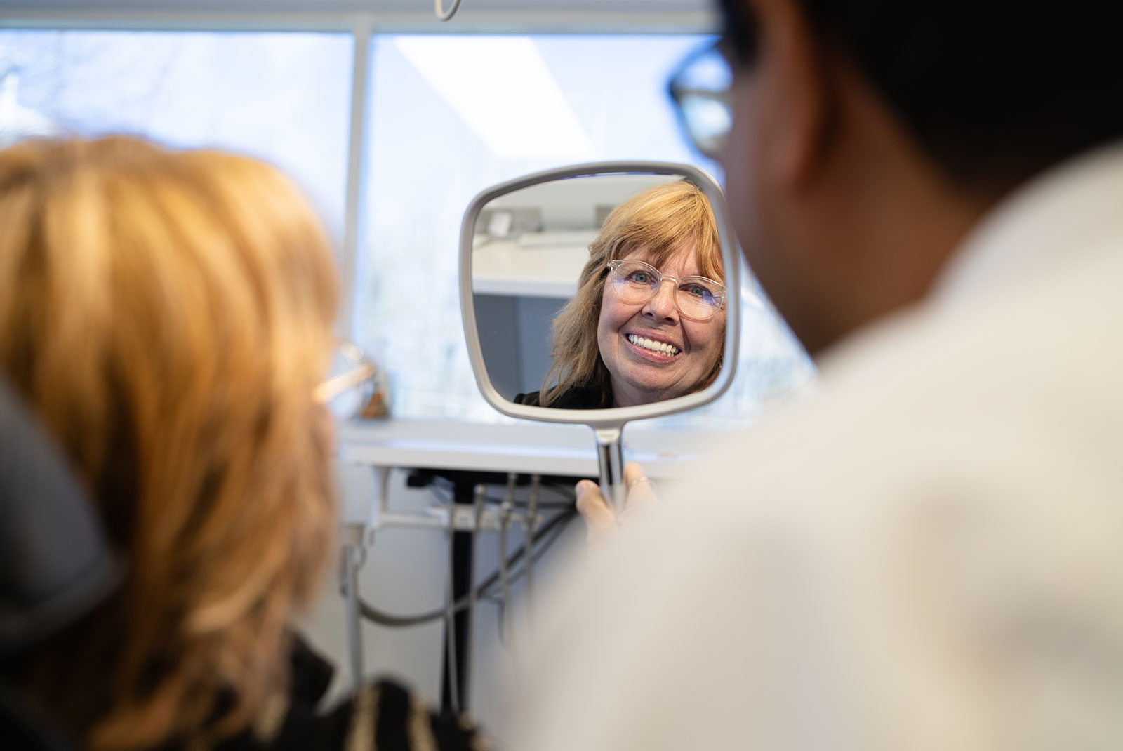 doctor and patient looking into mirror