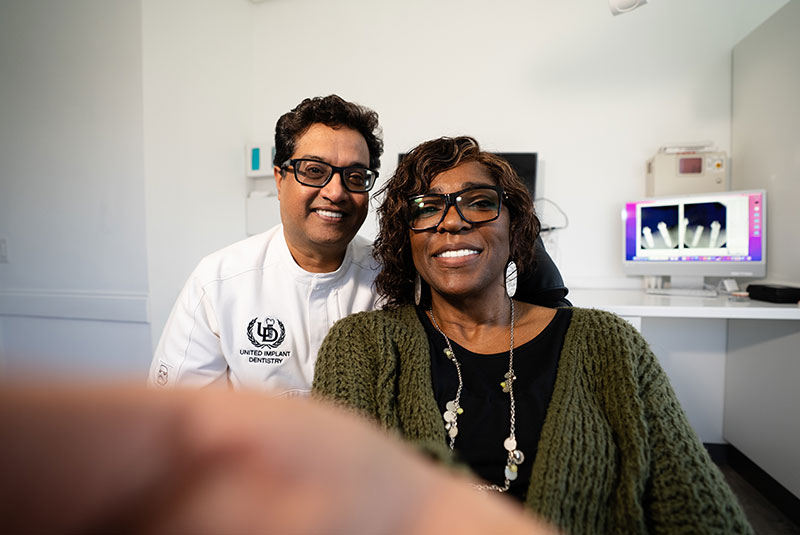 Patient looking into mirror to see new smile