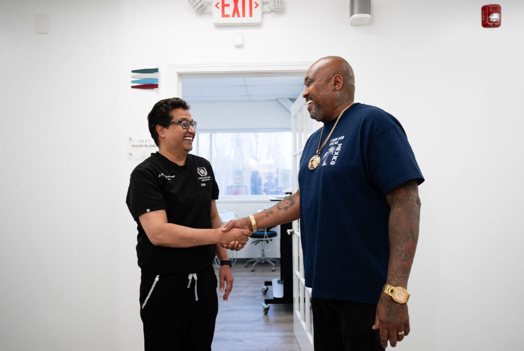 Patient shaking hands with dentist