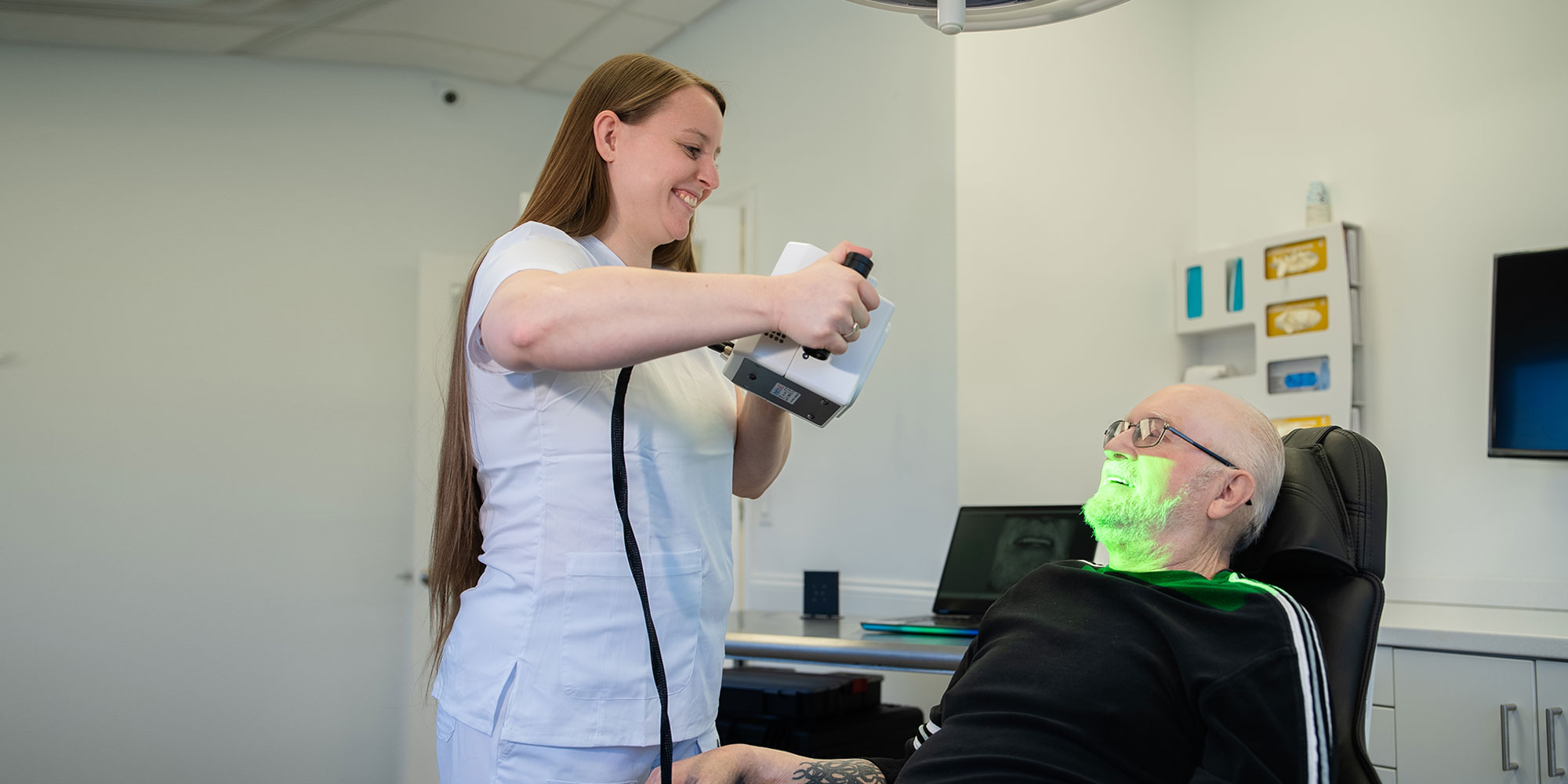 Team member taking photo of patients teeth