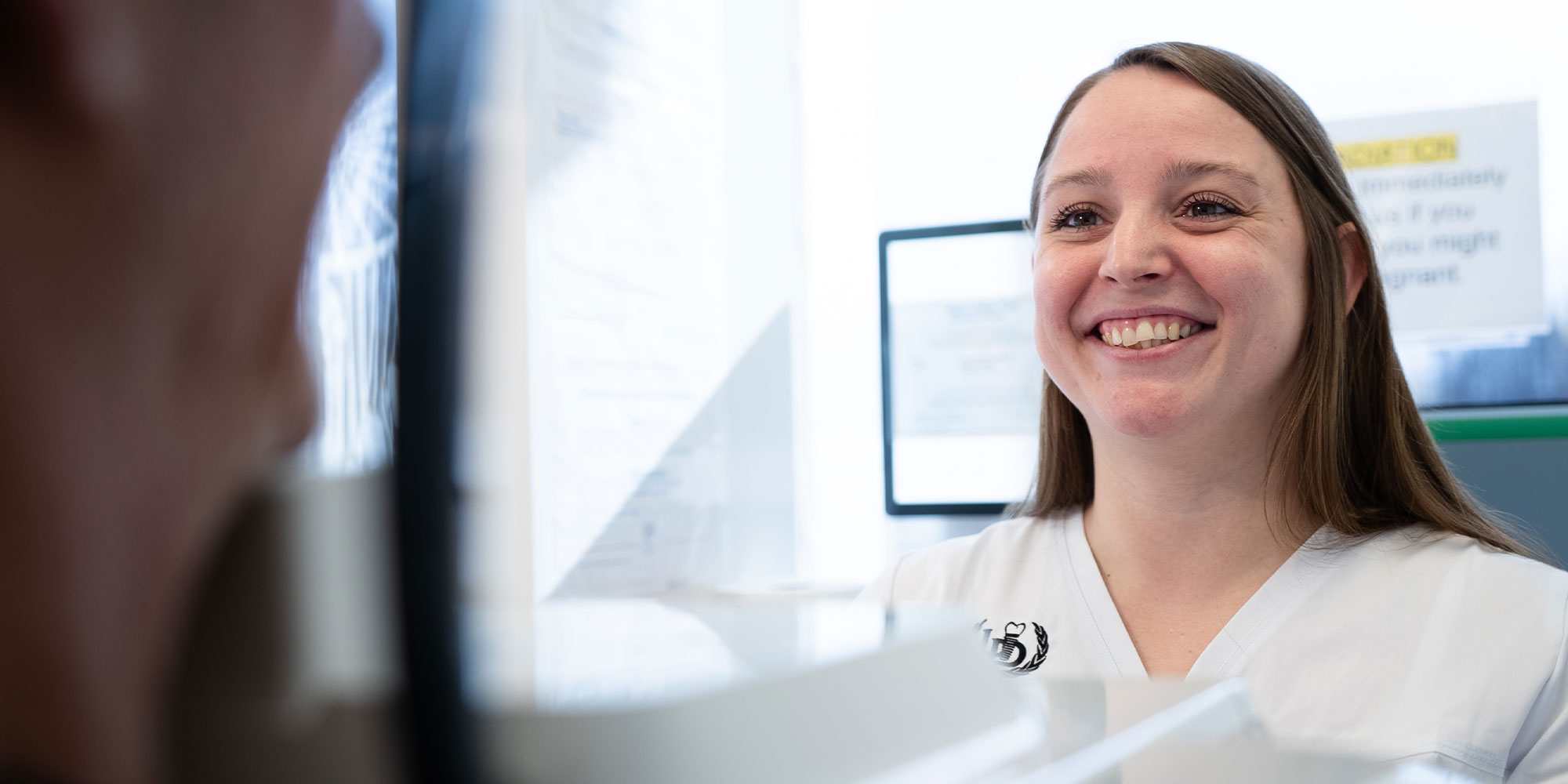Team member taking a dental x-ray of a patient