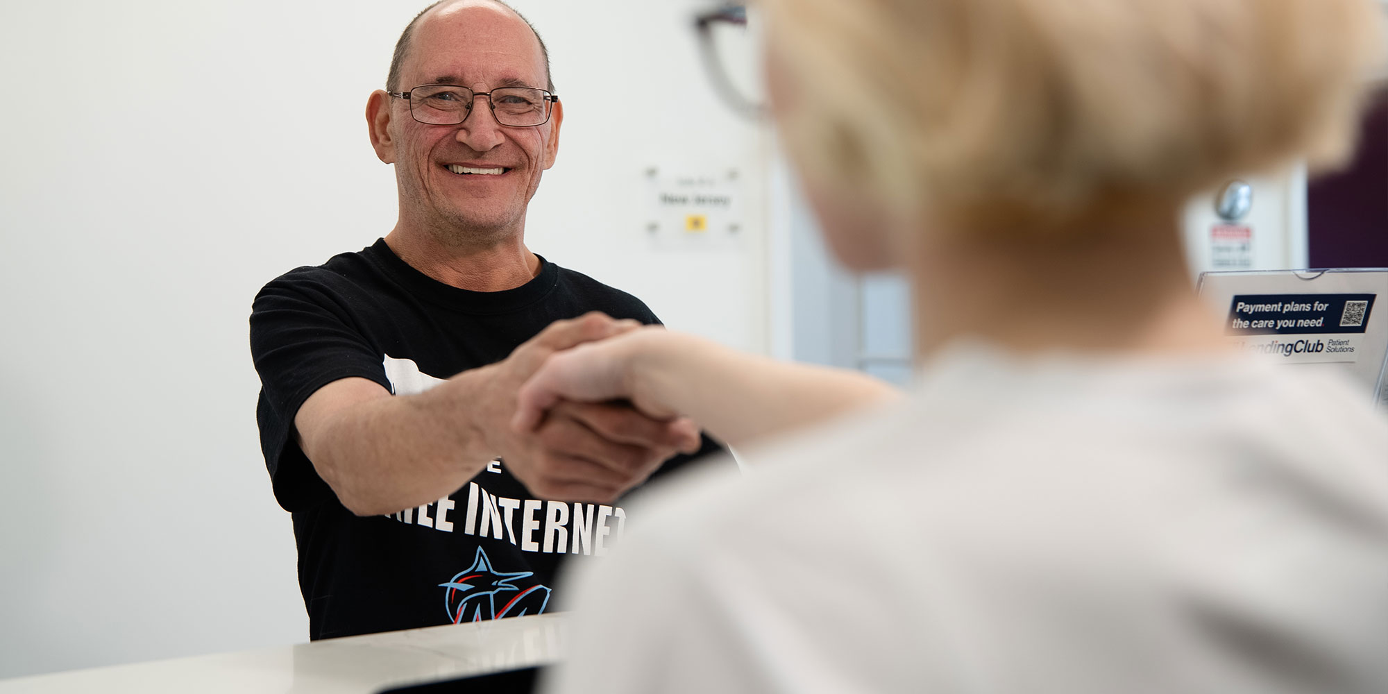 team member shaking patients hand